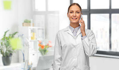 Image showing female doctoror calling on smartphone at hospital