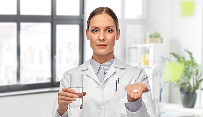 Image showing female doctor with medicine and glass of water