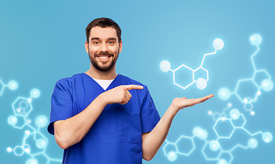 Image showing smiling male doctor showing molecule formula