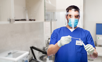 Image showing male doctor in mask with cotton swab and test tube