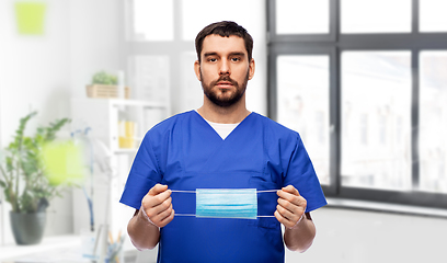 Image showing male doctor in blue uniform with mask