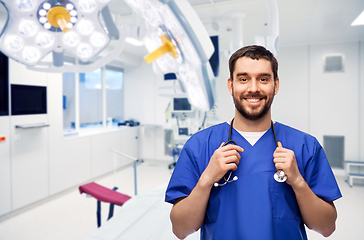 Image showing smiling doctor or male nurse with stethoscope