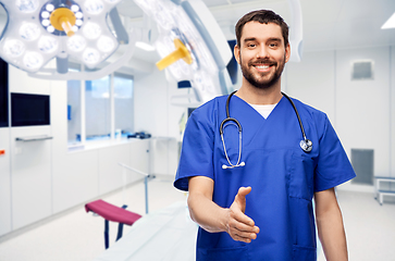 Image showing male doctor giving hand for handshake at hospital