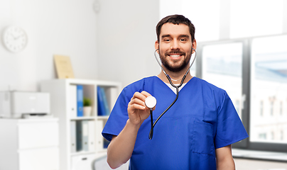 Image showing smiling male doctor or nurse with stethoscope