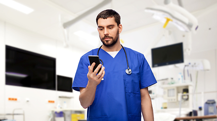 Image showing doctor or male nurse using smartphone