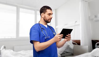 Image showing doctor or male nurse using tablet computer