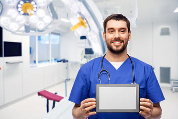 Image showing happy doctor or male nurse showing tablet computer