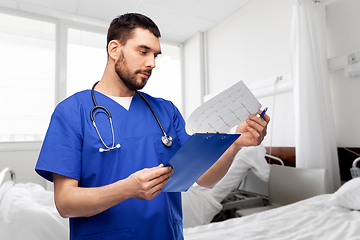 Image showing male doctor with cardiogram on clipboard