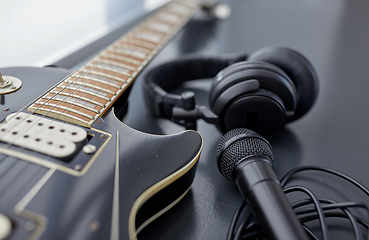 Image showing close up of bass guitar, microphone and headphones