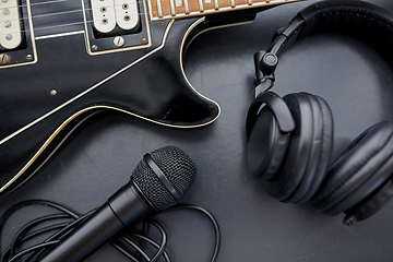 Image showing close up of bass guitar, microphone and headphones