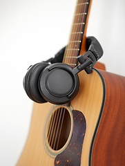 Image showing close up of acoustic guitar and headphones