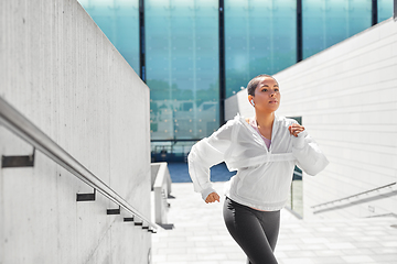 Image showing african american woman running upstairs outdoors