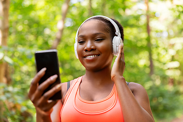 Image showing african american woman with headphones and phone