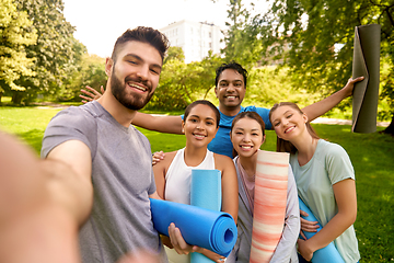 Image showing people with yoga mats taking selfie at park