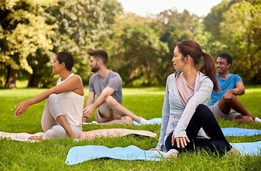 Image showing group of people doing yoga at summer park