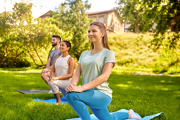 Image showing group of people doing yoga at summer park