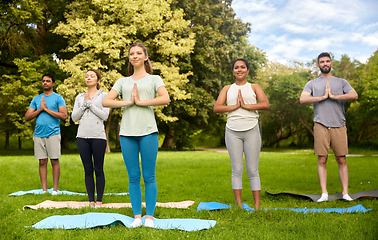 Image showing group of people doing yoga at summer park