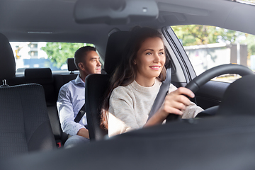 Image showing female driver driving car with male passenger