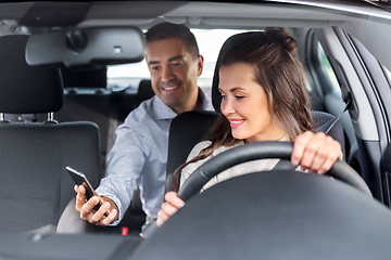 Image showing female driver driving car with male passenger