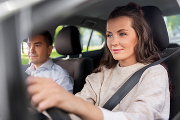 Image showing woman and driving school instructor in car