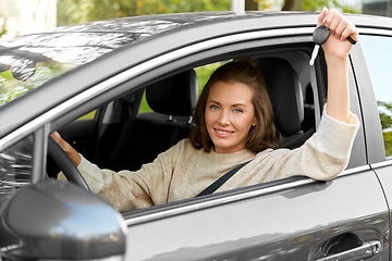 Image showing woman or female driver with car key in city