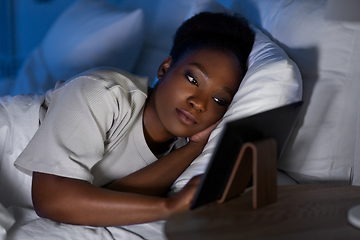 Image showing woman with tablet pc in bed at home at night