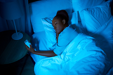 Image showing woman awaking because of alarm clock at night