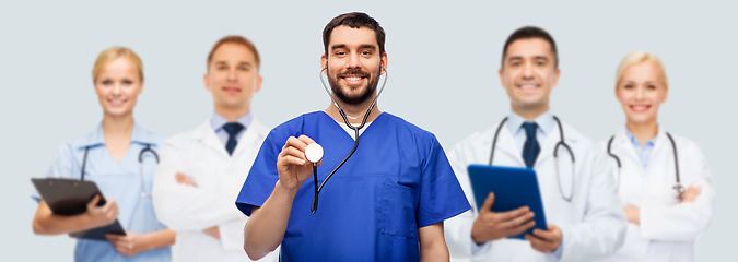 Image showing smiling male doctor or nurse with stethoscope