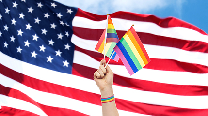 Image showing hand with gay pride rainbow flags and wristband