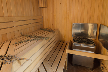 Image showing Interior of a sauna in a private house with an electric boiler