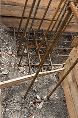 Image showing Reinforcement of the corner of the strip foundation, the trench is partially covered with earth