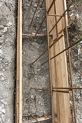 Image showing Partially buried bonded reinforcement and strip foundation formwork