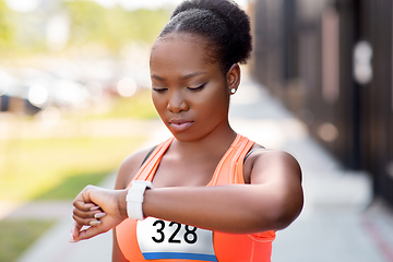 Image showing african female marathon runner with smart watch