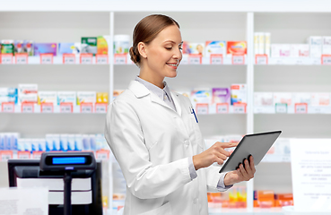 Image showing female doctor with tablet pc at pharmacy