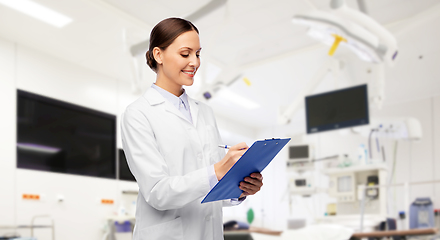 Image showing smiling female doctor with clipboard at hospital