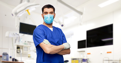 Image showing male doctor in blue uniform, mask and gloves