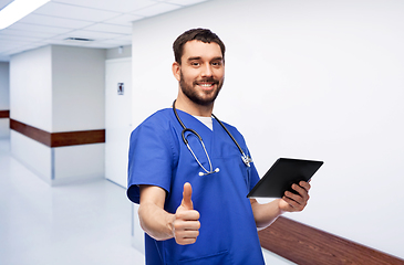 Image showing male doctor with tablet pc showing thumbs up