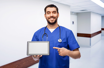 Image showing happy doctor or male nurse showing tablet computer