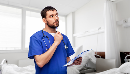 Image showing doctor or male nurse with clipboard