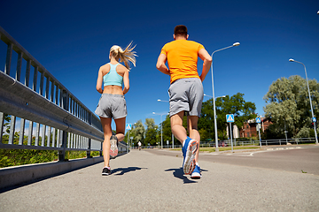 Image showing sporty couple running outdoors