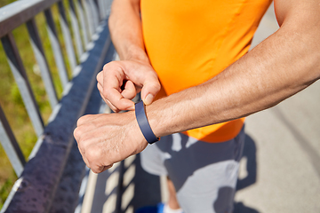 Image showing close up of man with fitness tracker outdoors