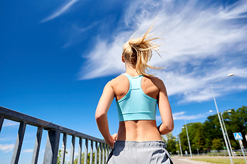 Image showing sporty young woman running outdoors