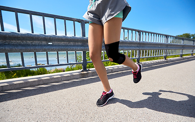 Image showing feet of young woman running outdoors