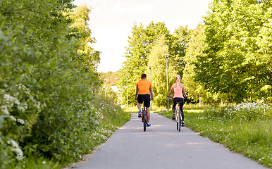 Image showing young couple riding bicycles in summer park