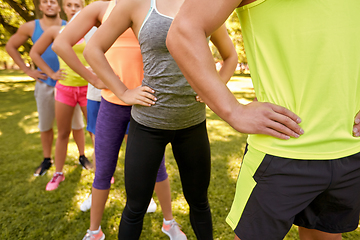 Image showing close up of people exercising with trainer at park