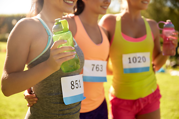 Image showing happy young sporty women with racing badge numbers