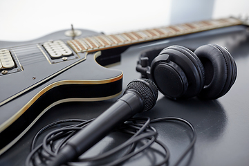 Image showing close up of bass guitar, microphone and headphones