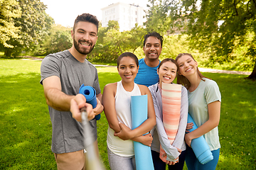 Image showing people with yoga mats taking selfie at park