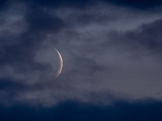 Image showing Moon Waxing Crescent Through Clouds