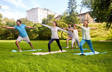 Image showing group of people doing yoga at summer park